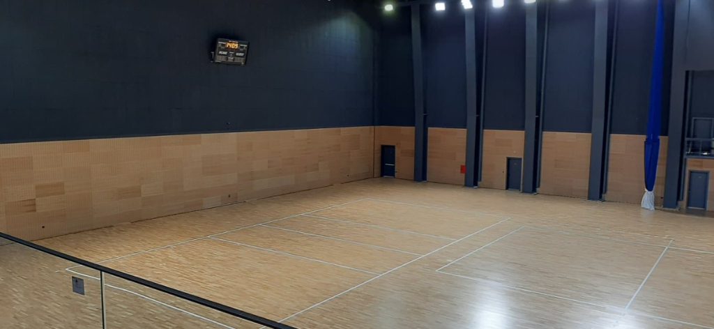 School gym floor in London freshly sanded and ready for sports and assemblies after our professional restoration.