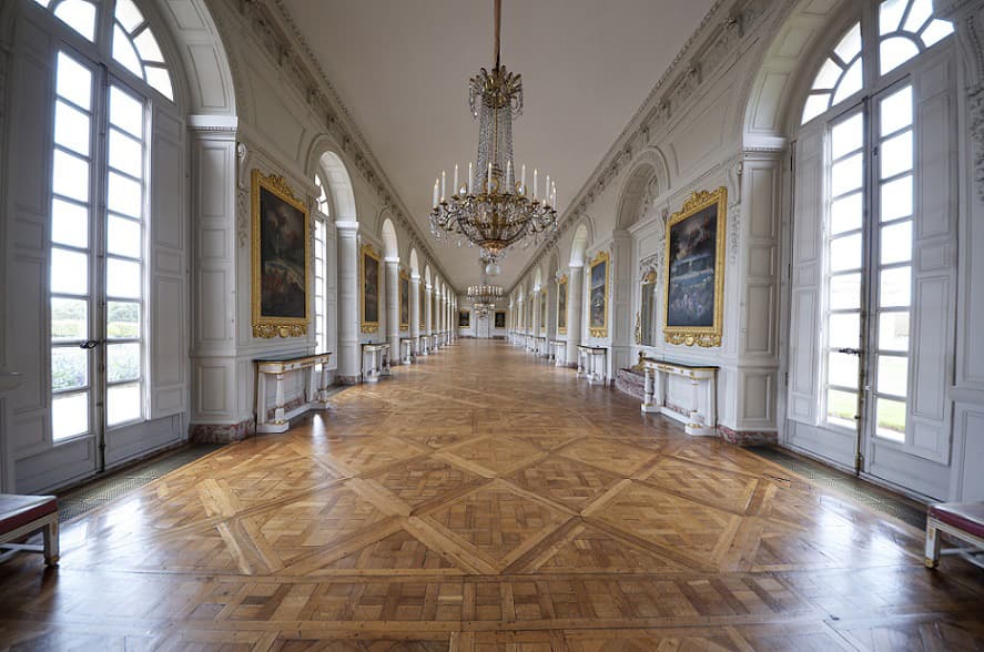 Versailles parquet pattern showing elaborate geometric design with multiple wood species oak walnut borders and central medallion