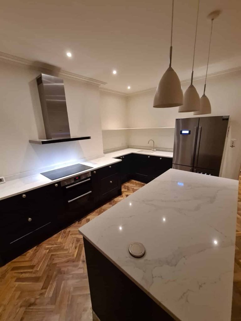 Luxury Chelsea kitchen featuring professionally polished Statuario marble worktops with waterfall edge island