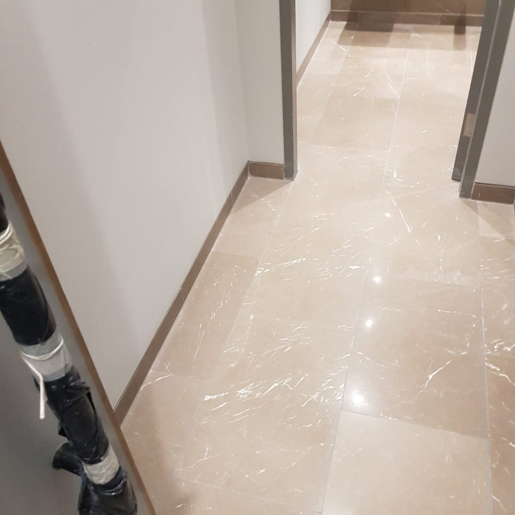 Perfectly polished limestone hallway floor in an Islington property, professionally restored to like-new, high-gloss finish by our specialist team.
