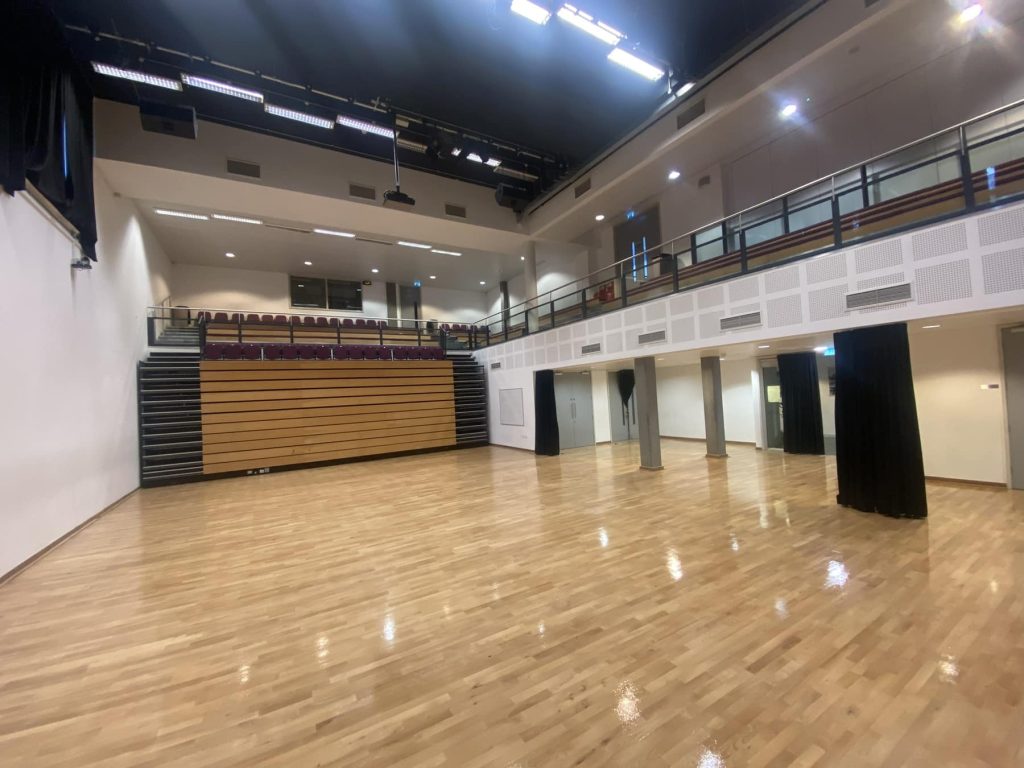 Freshly sanded and polished community hall floor in London – smooth, even, and finished with commercial-grade sealant for high-traffic public use.